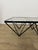 Alanda square coffee table with a black painted iron frame and glass top, designed by Paolo Piva for B&B Italia in the...