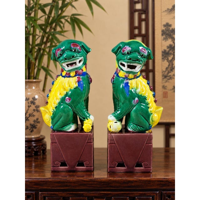 A wonderfully expressive pair of mid-20th-century Chinese ceramic guardian lions, traditionally known as Foo Dogs,...
