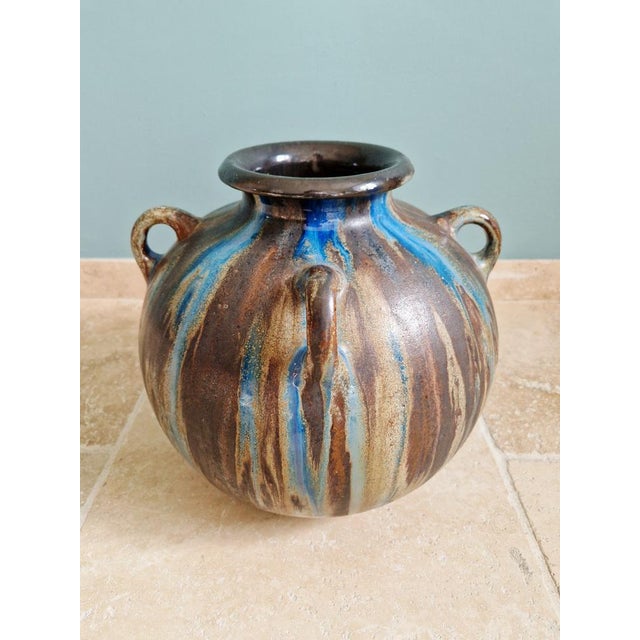 Large vase with four handles in flamed stoneware, made by the Belgian ceramist Roger Guérin in the Bouffioulx workshops...