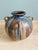 Large vase with four handles in flamed stoneware, made by the Belgian ceramist Roger Guérin in the Bouffioulx workshops...