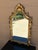 An elegant Italian giltwood mirror featuring a richly carved Rococo frame with scrolling acanthus details and original...