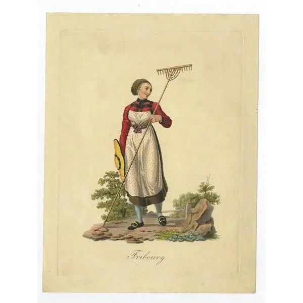 Antique costume print titled 'Fribourg'. This print depicts a farmer's wife from Fribourg, Switzerland. Source unknown, to...