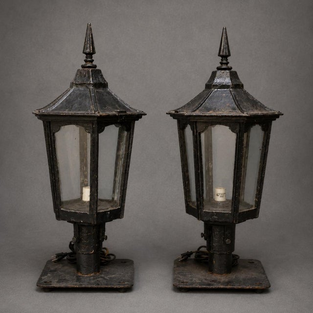 This striking set of 20th Century English Iron Lanterns brings timeless European character and architectural charm to both...