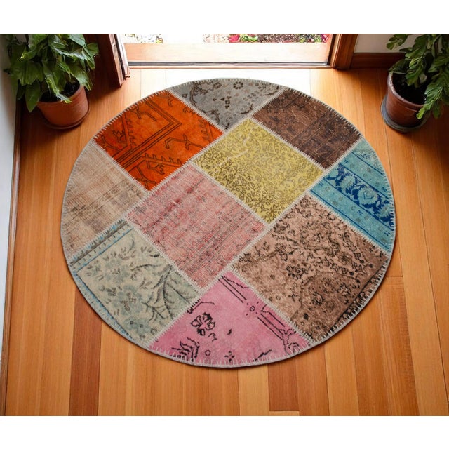 This sophisticated circular patchwork rug is a contemporary masterpiece composed of meticulously selected vintage...