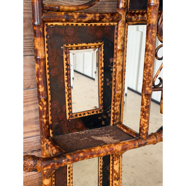 An exceptional and highly decorative late 19th century English Aesthetic Movement bamboo mirror étagère, featuring an...
