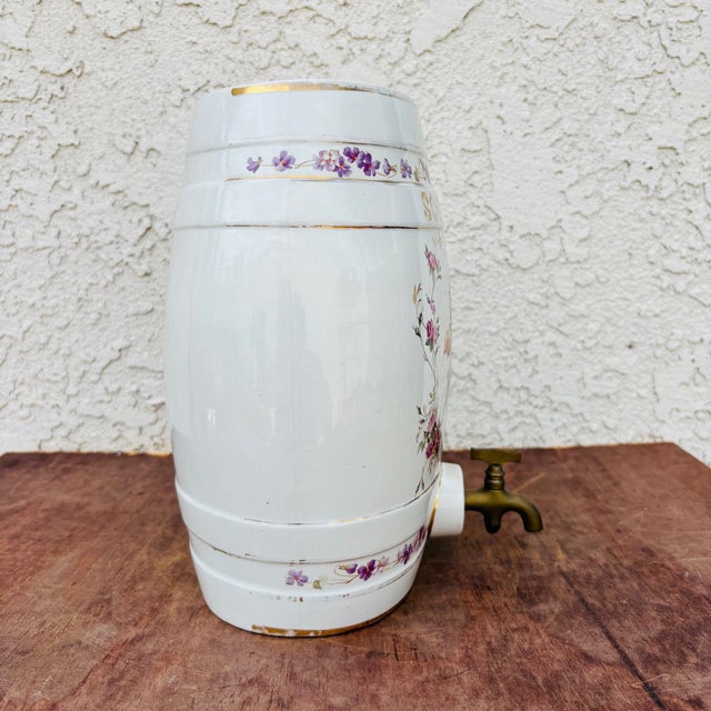 A beautifully decorative antique English ceramic spirit barrel, richly adorned with hand-colored transferware fruit and...