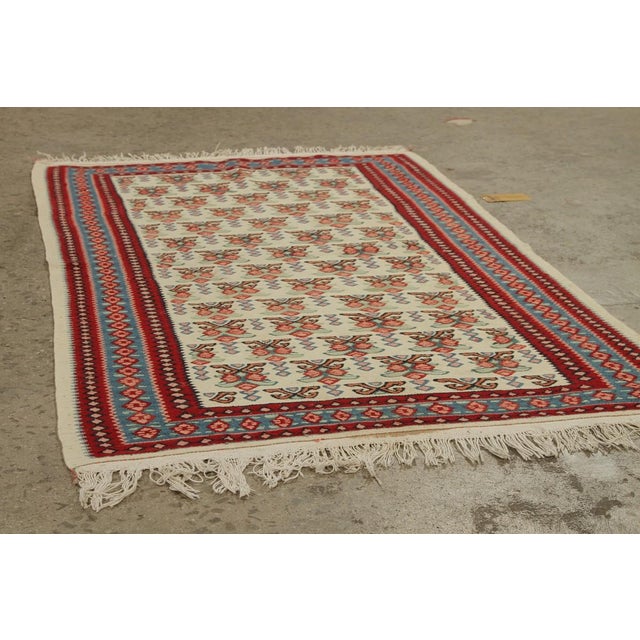 Handwoven in wool, a 3x5 antique Senneh Kilim rug originating circa 1930-1940. The beautiful piece showcases a brilliant...