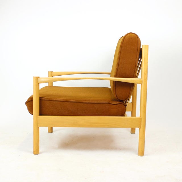 An elegant 1960s lounge chair from Czechoslovakia, showcasing the clean lines and refined craftsmanship characteristic of...