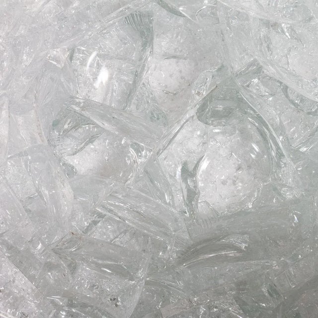 Rare and unusual coffee table fashioned out of a massive scrap glass melt pot. Melted and fused glass elements are on...