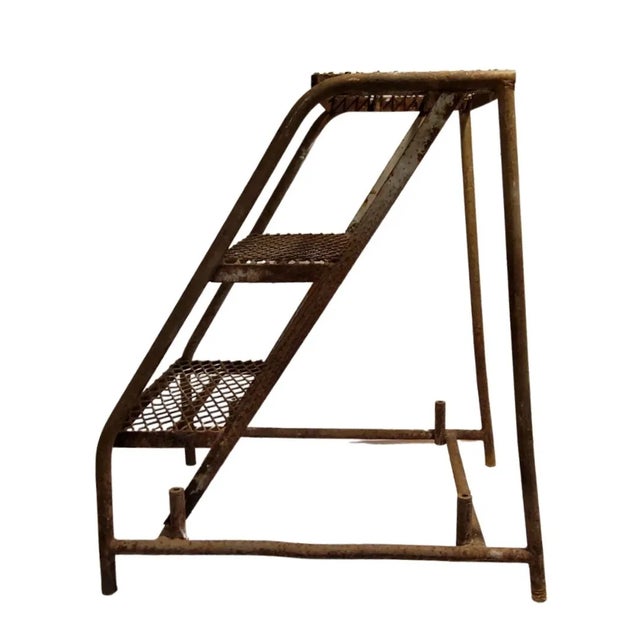 1940's industrial step ladder is 28.25 inches tall, 24.25 inches deep and 19.5 inches wide. It serves as a ladder and...