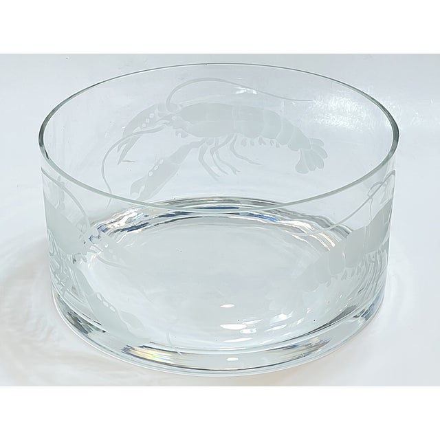 This is a good-sized glass bowl etched with lobsters. It is marked "Woodland Glass Arts '93." This appears to be a company...