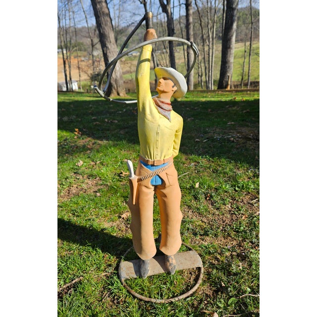 This vintage figural metal lawn sprinkler, shaped like a cowboy twirling a lasso, is believed to date from between 1930...