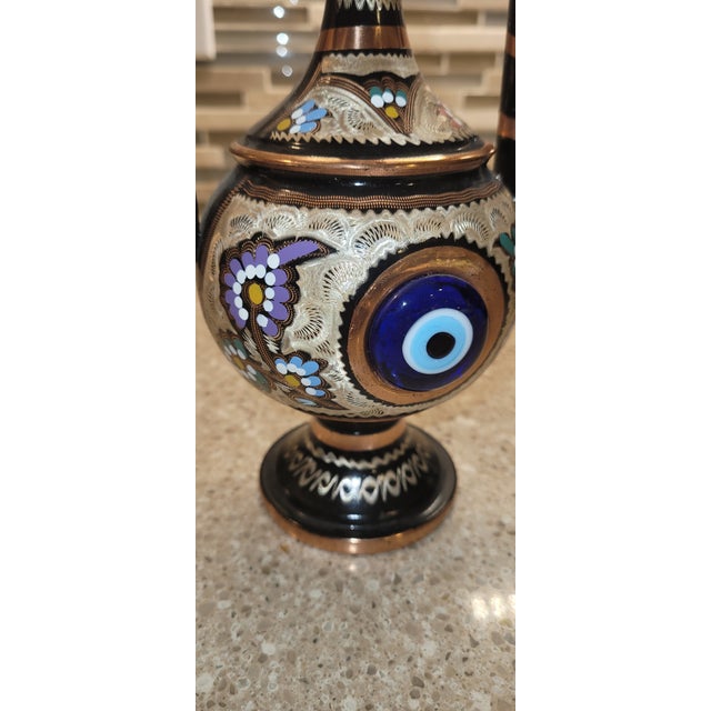This striking vintage Turkish decorative ewer features a traditional copper form embellished with black enamel, hand-...