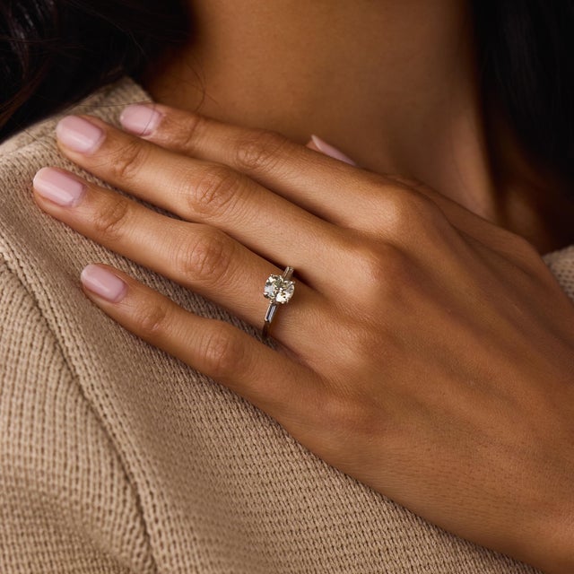 This elegant Mid Century diamond engagement ring is a timeless 1950’s design, centered by a GIA-certified old mine cut...