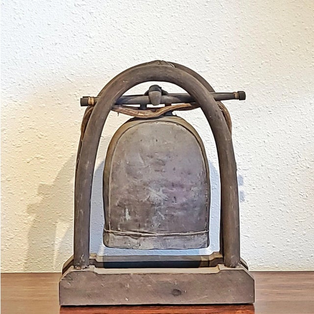A large antique cast bronze elephant bell from the Karen Hill Tribe of northern Thailand. It retains its wooden dowel...