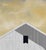 Summer Sunset by Justin Wheatley is an acrylic painting on panel of a white barn standing against a warm yellow sky....