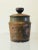 A glazed stoneware jar with lid. The expressive glaze patterns play off an olive colored background. A Robert Maxwell...
