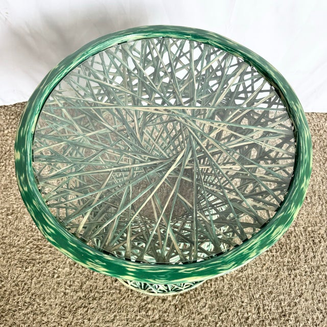 A whimsical twist on mid-century design, this circular side table features a sculptural hourglass form crafted from green...