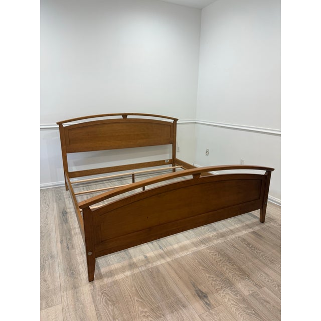 Ethan Allen Elements Collection King Size Bed frame, crafted from solid wood. The frame includes a headboard and footboard...