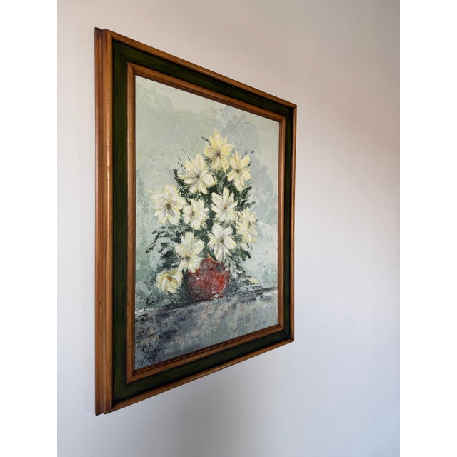 Beautiful 1969 vintage still life oil on canvas depicting a lush bouquet of white and pale yellow flowers arranged in a...