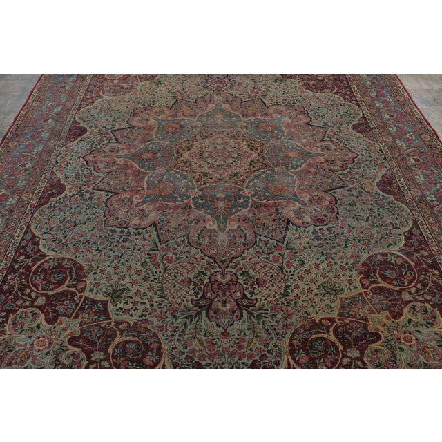 Made with hand-knotted wool, this 8x11 antique rug, circa 1920-1930, is a sophisticated addition to Rug & Kilim’s Persian...