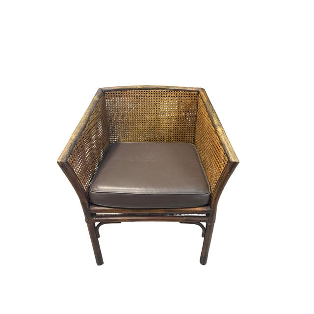 Authentic pair of Vintage McGuire Rattan & Cane Barrel Lounge Chairs. This pair of statement chairs bring an organic...
