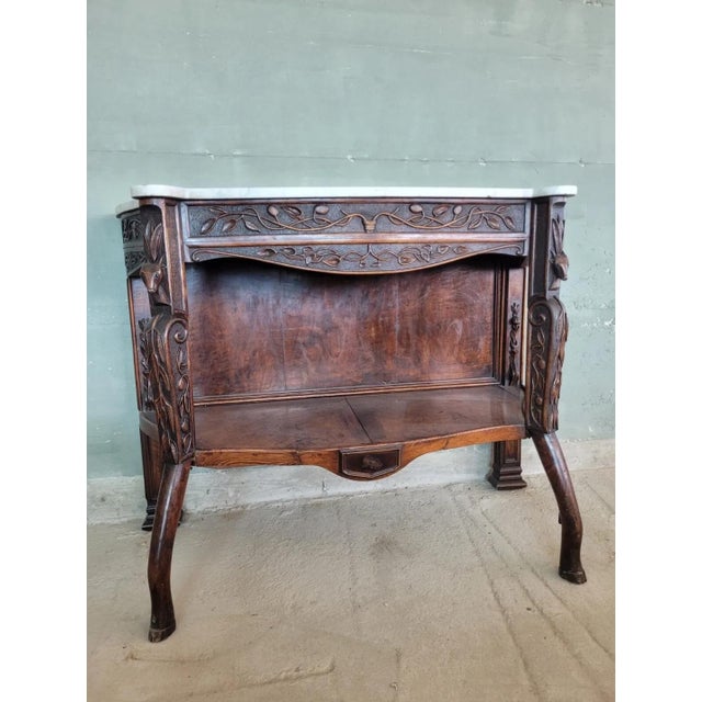 Art Nuveau sculpted console with white marble top. Particular piece of design dating back to the end of the 19th century