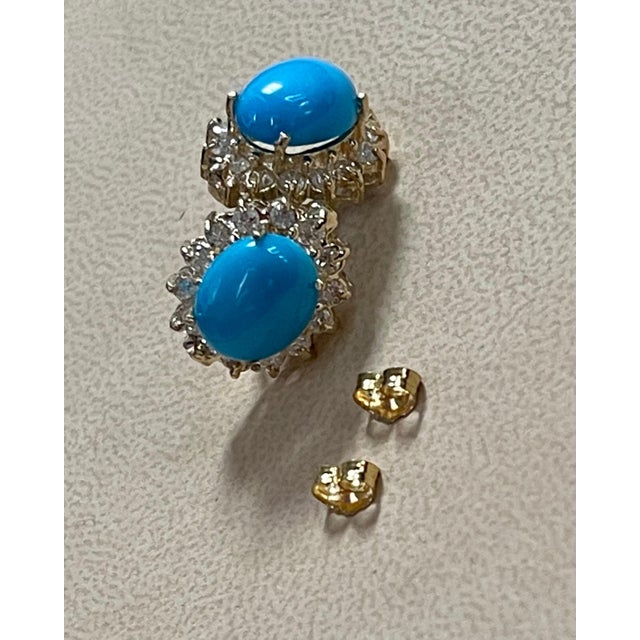 8 Ct Oval Sleeping Beauty Turquoise & 1.5 Ct Diamond Stud Earrings 14 Karat Yellow Gold, Post Back This exquisite pair of...