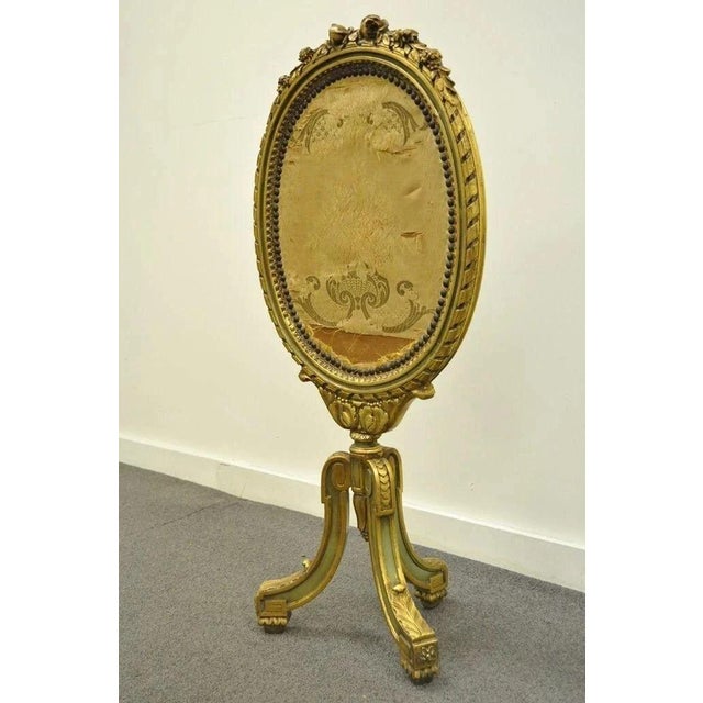 Antique French Louis XVI / XV Style Carved Giltwood Green & Gold Oval Fireplace Screen. Item features beautiful carved...