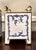 A handsome pair of square, tapered cachepots in the classic blue-and-white chinoiserie style, hand-painted with a delicate...