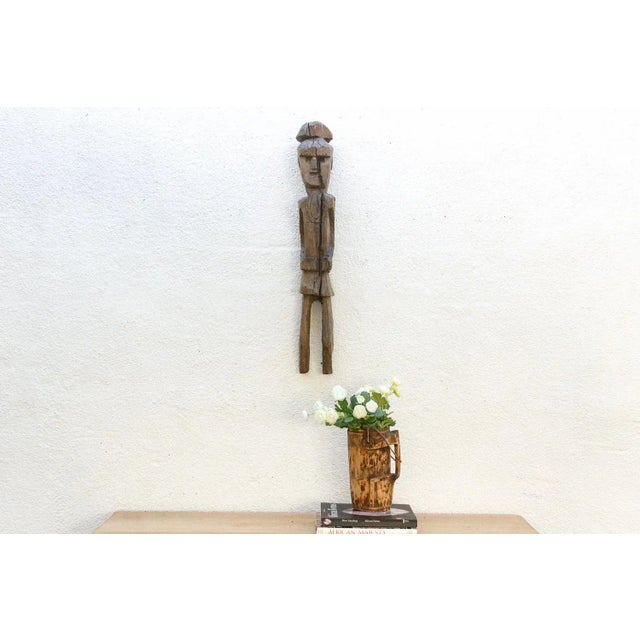 This magnificent figure is a rare and powerful ancestral relic, its history etched into its weathered surface. This...