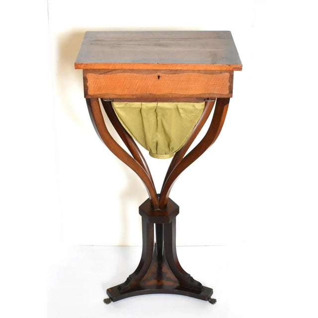 An antique late 18th to early 19th-century French Empire, Napoleon I, work / sewing table in rosewood and mahogany,...