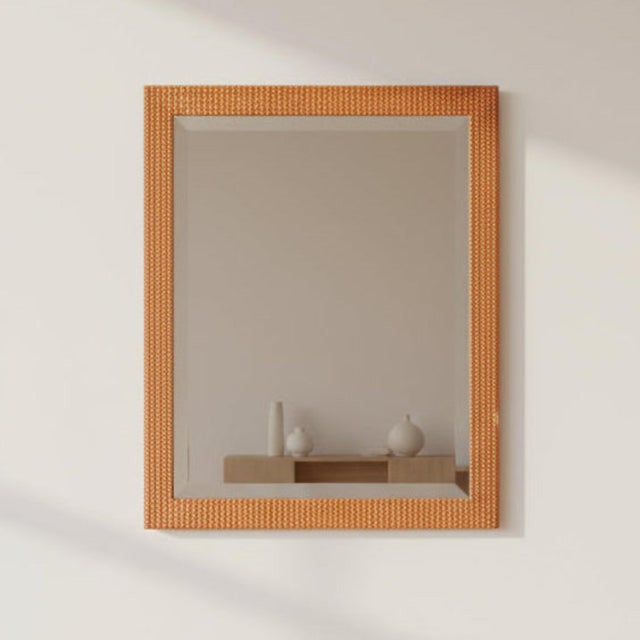 The Vintage irror features a orange-tone wood frame accented by a white zigzag detail. Condition: Vintage condition, small...