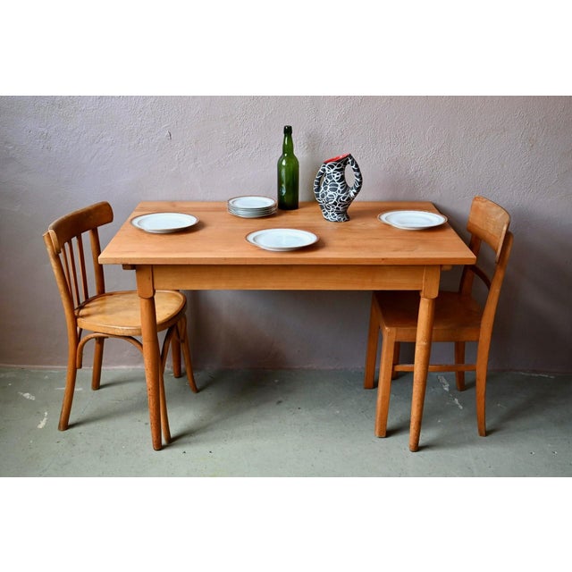 We love this little retro table! Rectangular but compact, this 1960s table is made entirely of wood. Its tapered legs are...