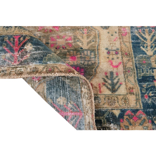 Beautiful Vintage Shabby Chic hand-knotted wool rug with a beige field. This Rug has accents of pink and blue all-over a...