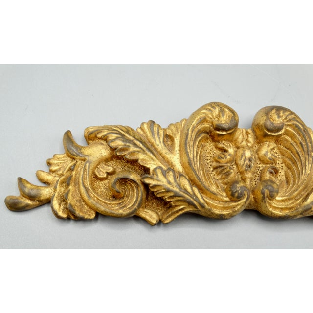 French hand carved giltwood pediment architectural element. This lovely handcrafted piece is the perfect accent hung above...