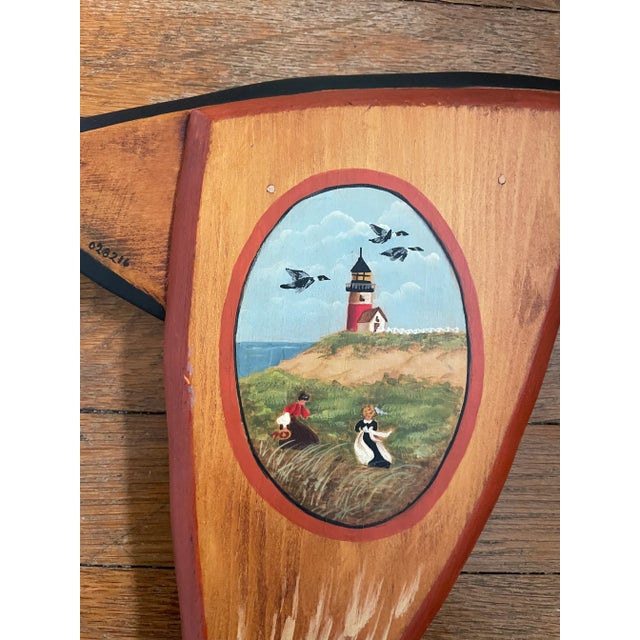 Wooden folk art goose, hand painted with two autumn scenes on each wing and outlined in black. Signed Carol Dean.