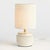 With a wide, repeating ribbed pattern and antiqued reactive glaze, this little lamp brings the character. The long, narrow...