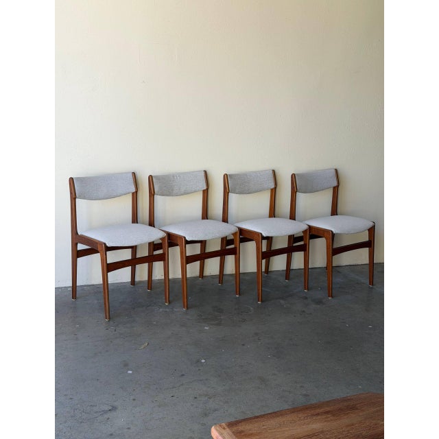Set of four vintage Danish Mid-Century Modern dining chairs in style of Erik Buch, crafted in beautiful warm teak. These...