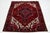 This vintage Persian Heriz hand-knotted wool rug showcases a striking red field with bold blue and beige accents in an...