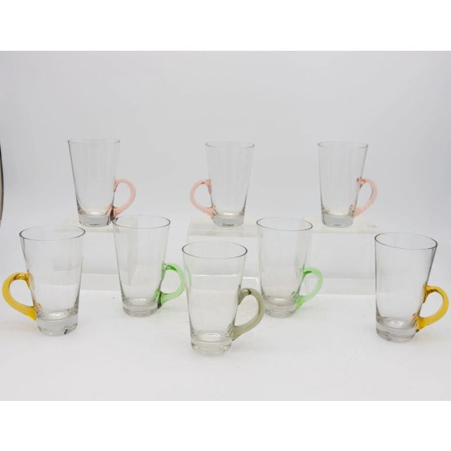 A delightfully whimsical set of eight vintage Hot Toddy glasses. Each glass has a pale pink, yellow, green, or gray...