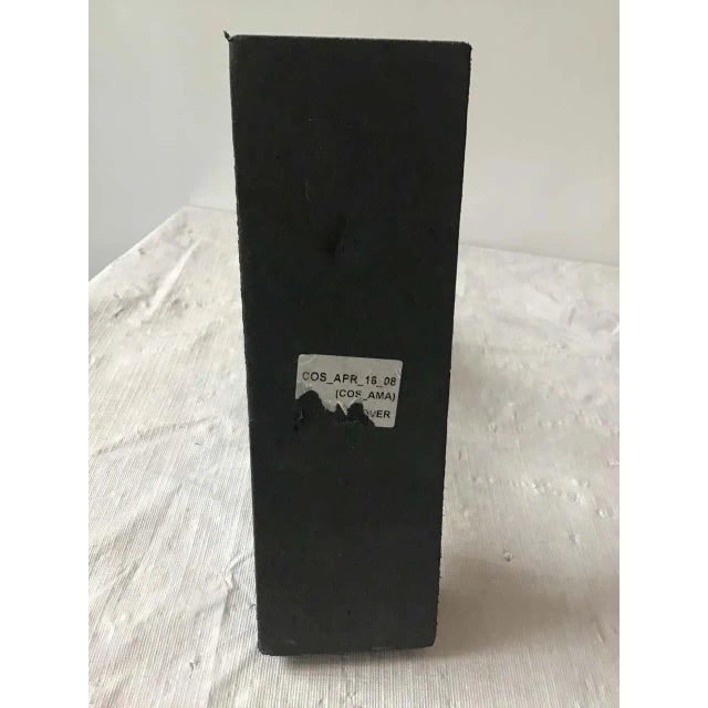 Gilt iron sculpture of man on a granite base. Dated 2008.