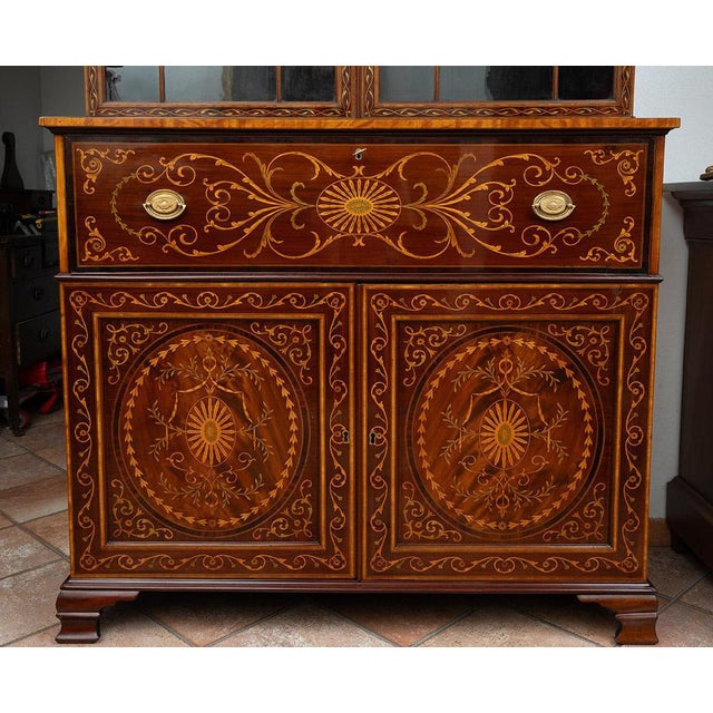English mahogany feather bookcase with maple floral pattern inlay grafts belonging to the early 19th century. The lower...