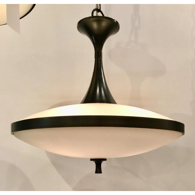 Original Retail $1908, stylish Currey & Co. Modern Electress Iron and Frosted Glass Pendant, showroom floor sample