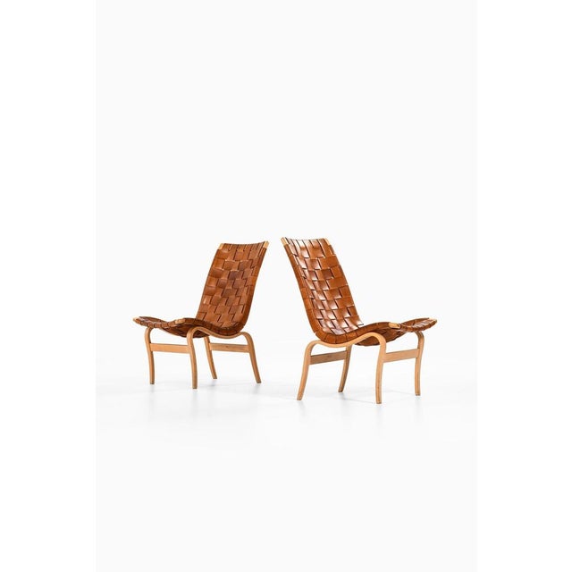 Pair of easy chairs in laminated birch and original leather webbing by bruno mathsson, 1968 additional information:...
