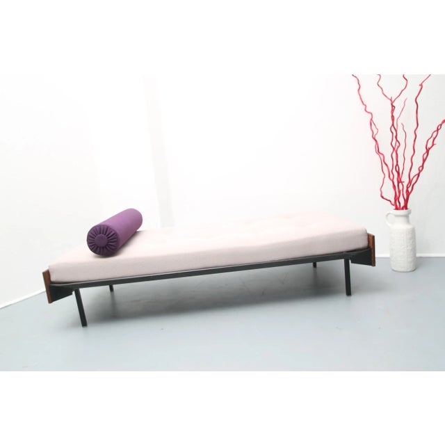 This vintage daybed sofa was designed during the 1960s and produced in the Netherlands. It is made from metal and wood...
