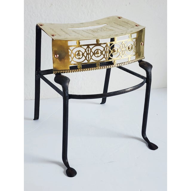 Antique circa 1870, Victorian brass and iron trivet or footman, with pierced bow front, engraved top, and splayed legs.