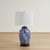 Alluring pair of Chinese porcelain table lamps hand decorated with white floral motifs on a blue background having unique...