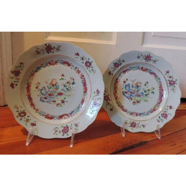 Antique pair of Chinese export porcelain plates decorated in a famille rose palette with a European subject of the bird...