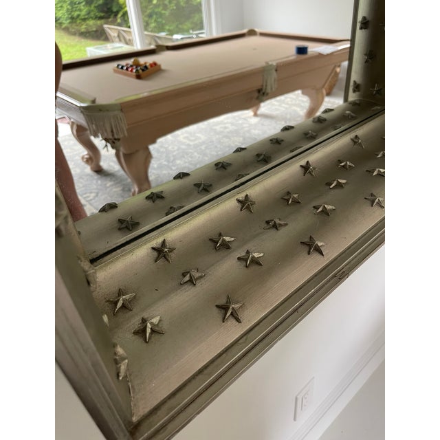 A deeply recessed gilt frame and star encrusted rectangular mirror by award-winning interior design veteran Bunny...